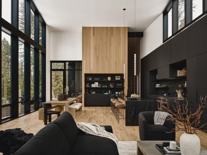 Interiors with high ceilings, black trim and a wooden wall detail