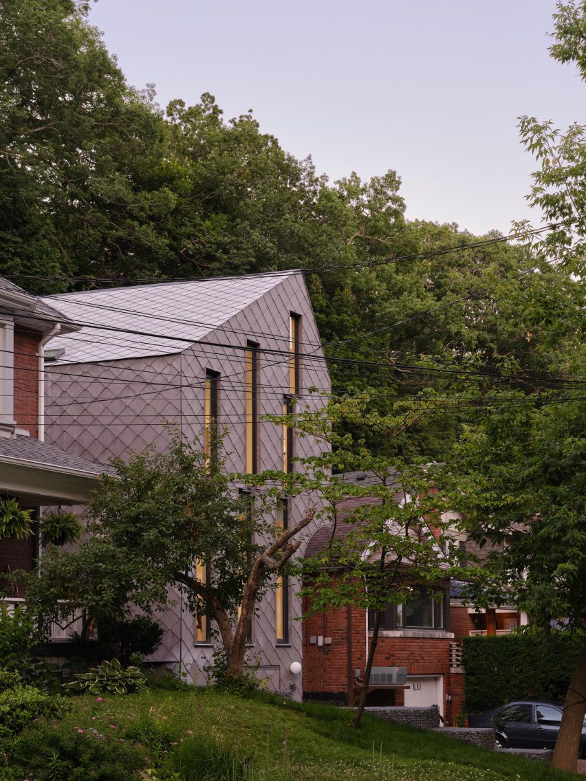 House with diamond-shaped panels through trees in Toronto neighbourhood