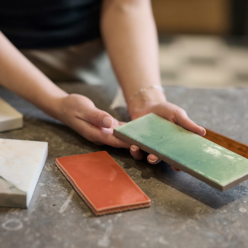 a photograph of a person holding tiles