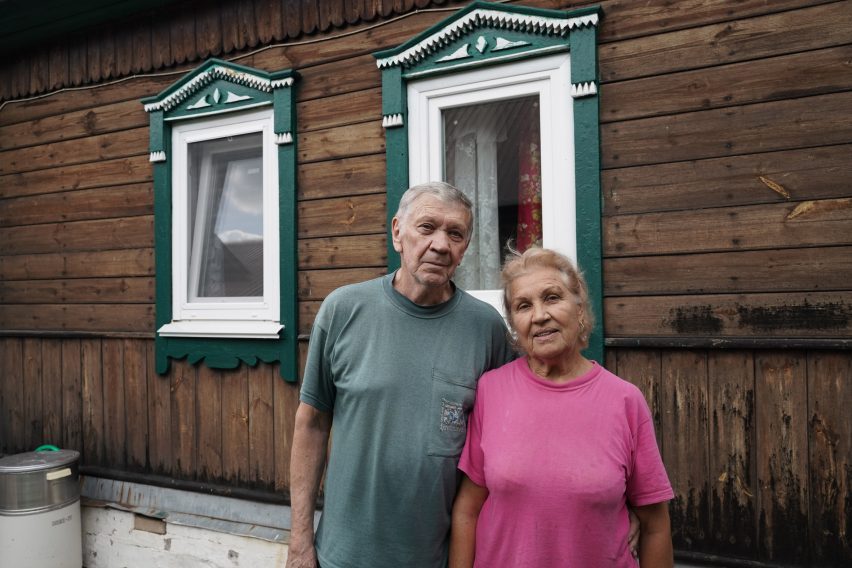 A couple in front of their home