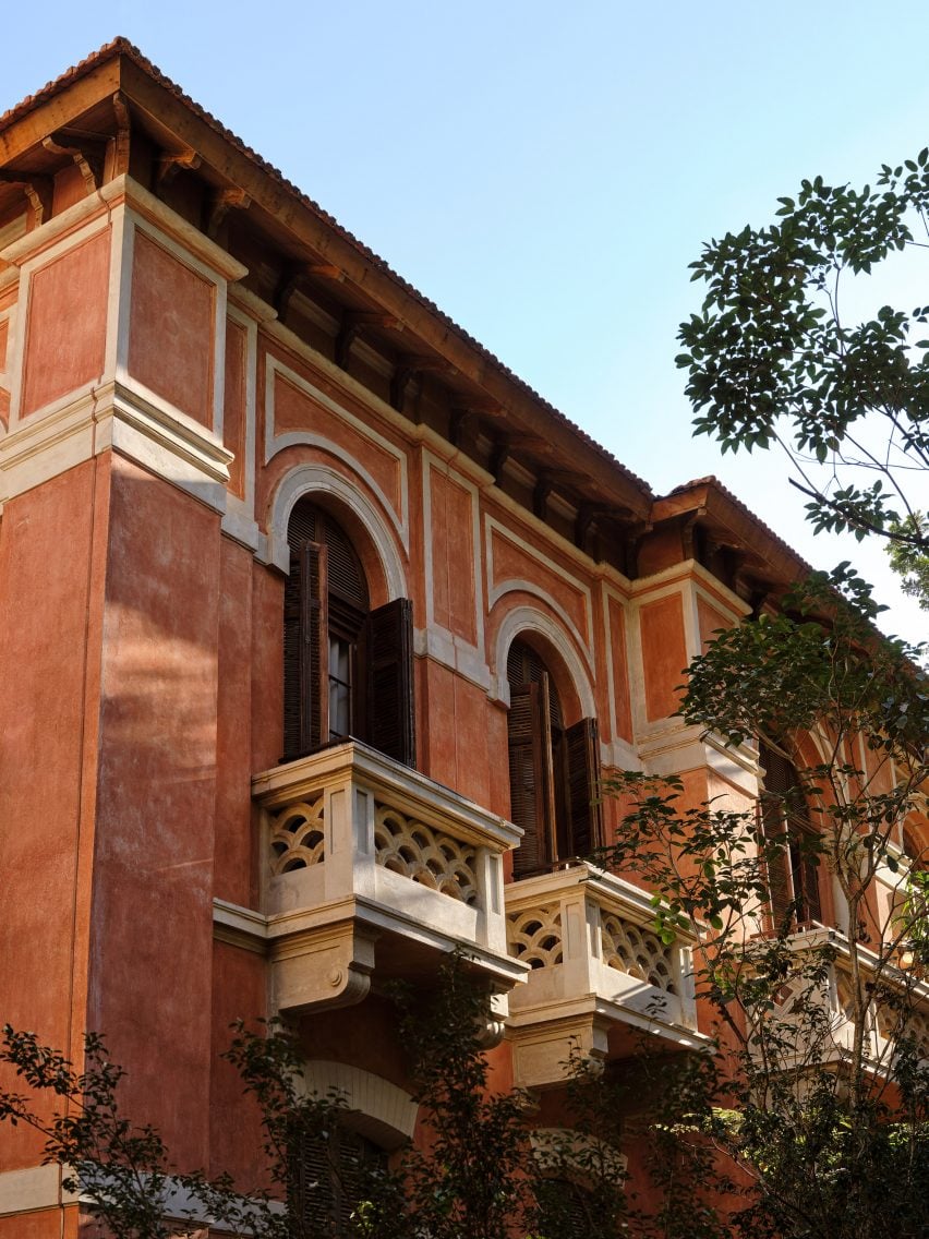 Exterior view of an early 20th century Italian style building with red walls