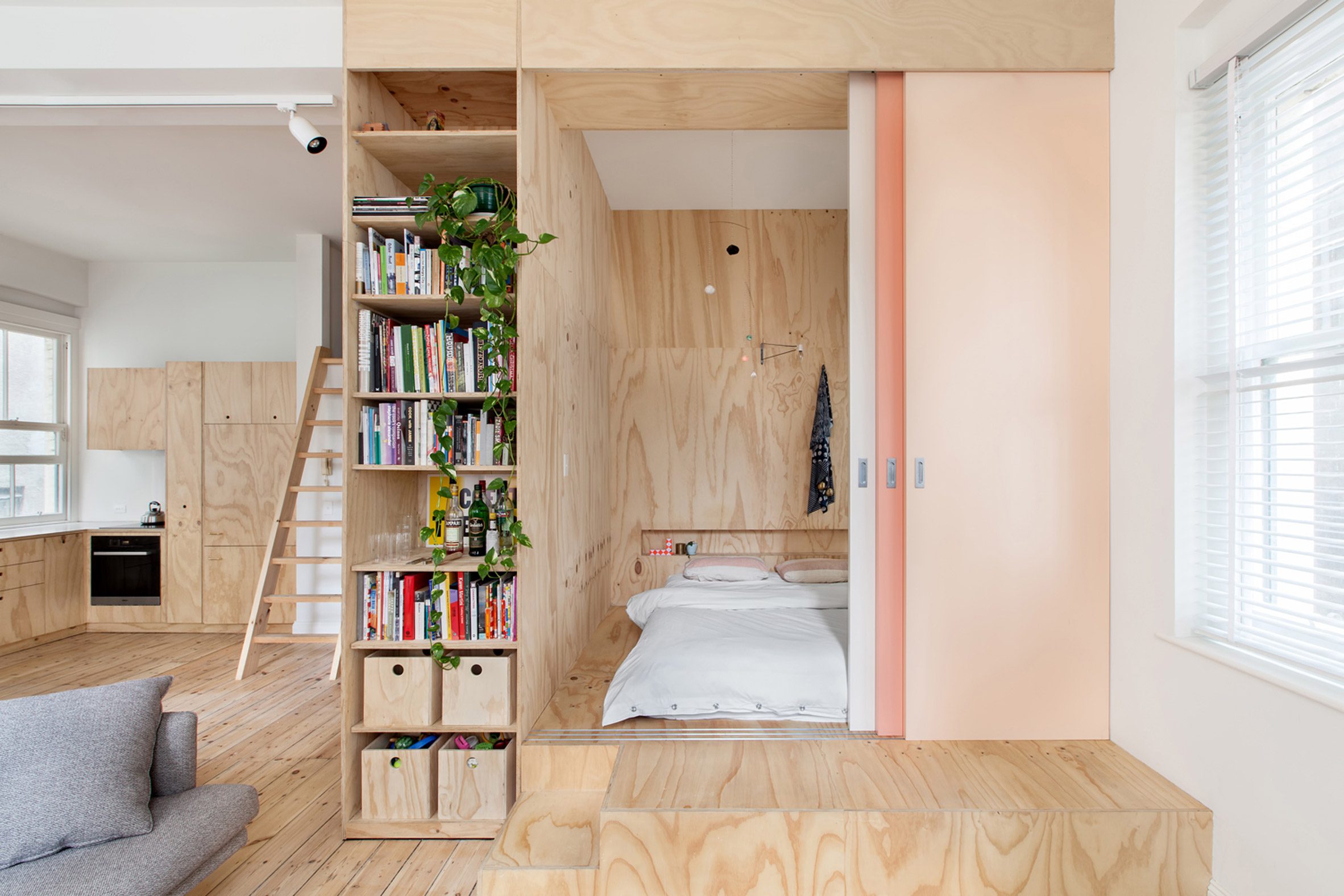 Bedroom with plywood storage room divider wall