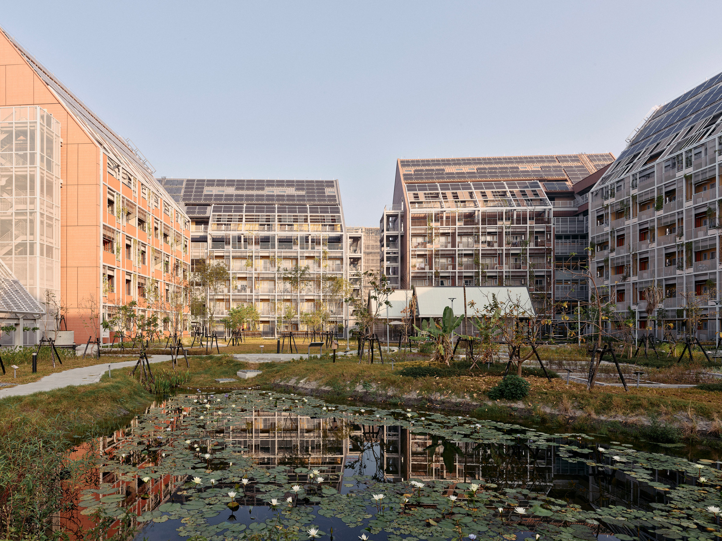 Pond at centre of Taisugar Circular Village by Bio-Architecture Formosana