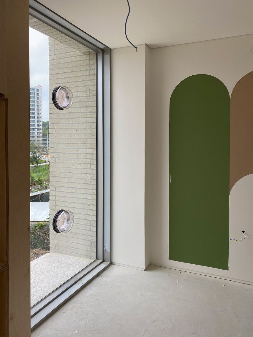 Photo of two Ublo porthole windows installed on a fixed window panel in a building