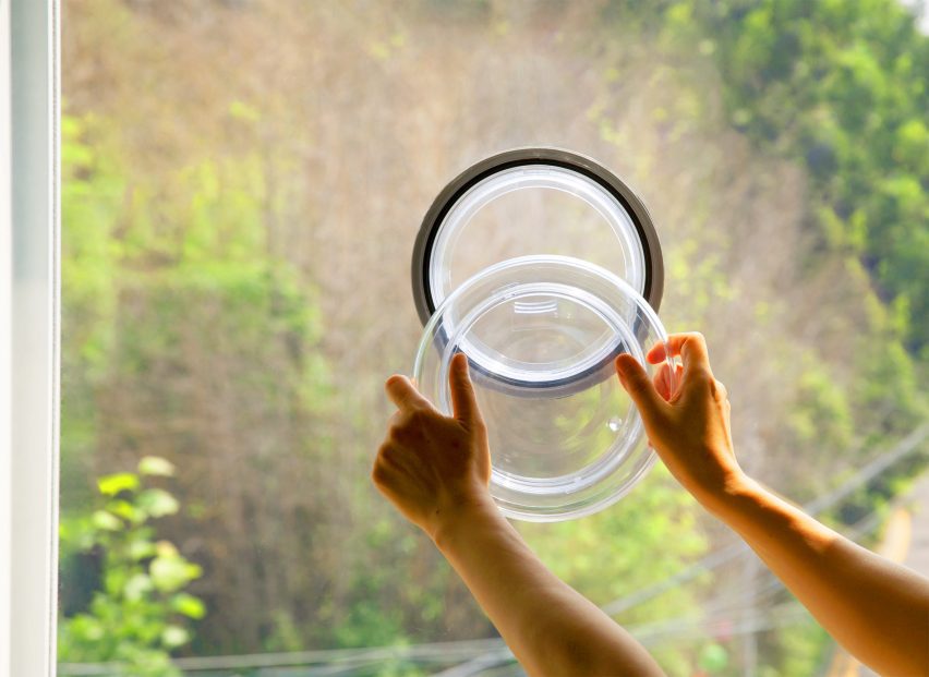 Close-up photo of a person opening an Ublo window