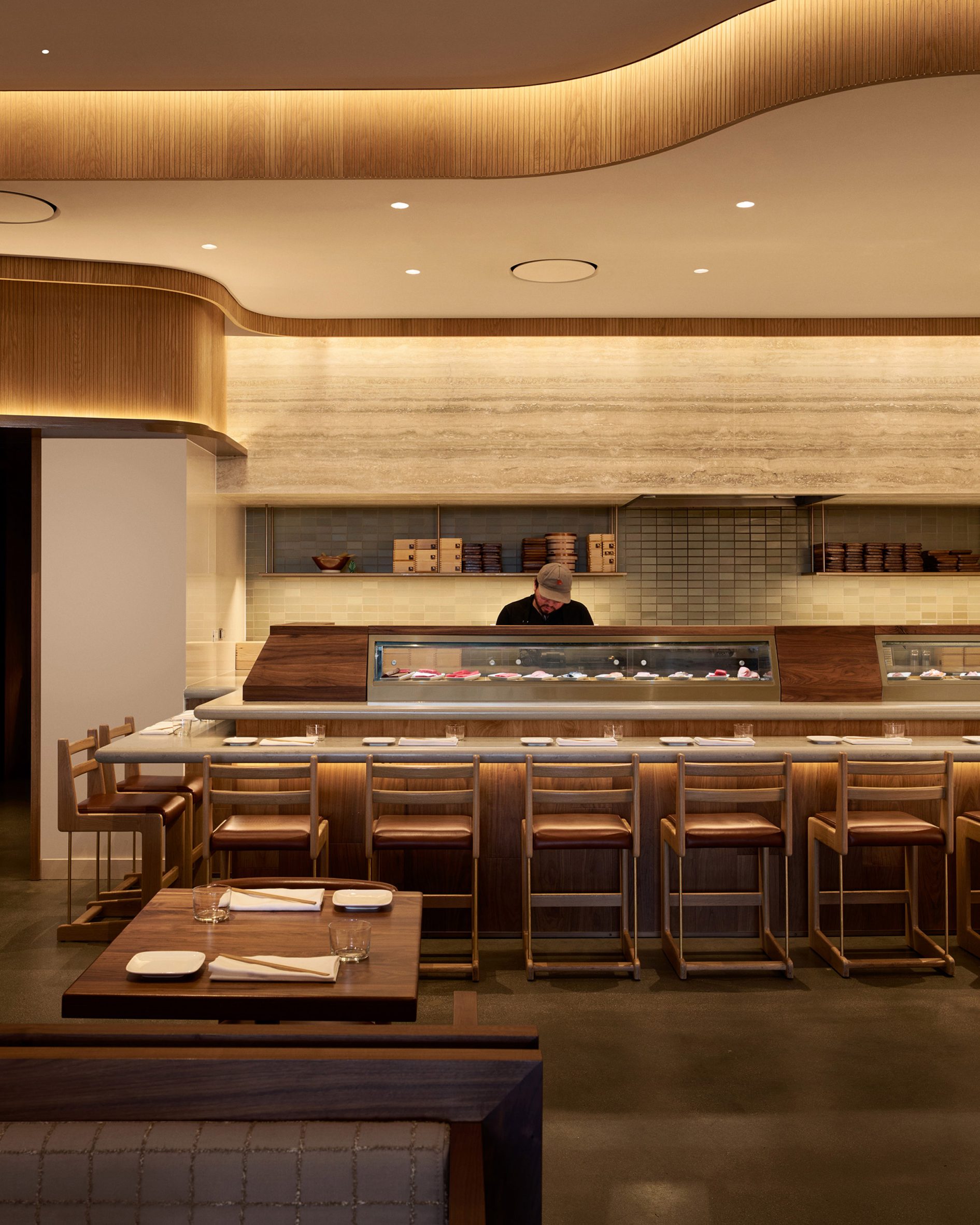 Sushi bar with travertine mounted behind