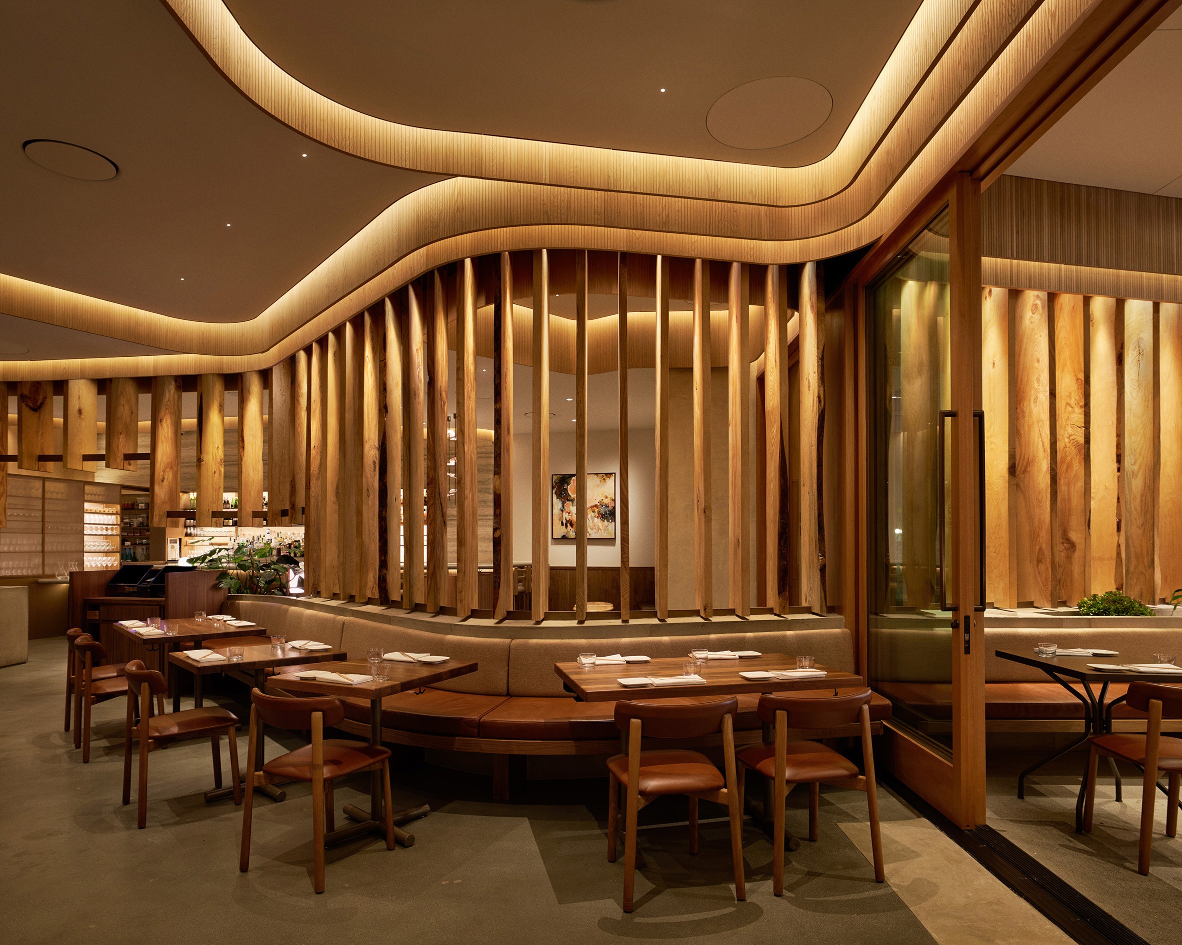 Restaurant interior with live-edge wood boards dividing seating areas