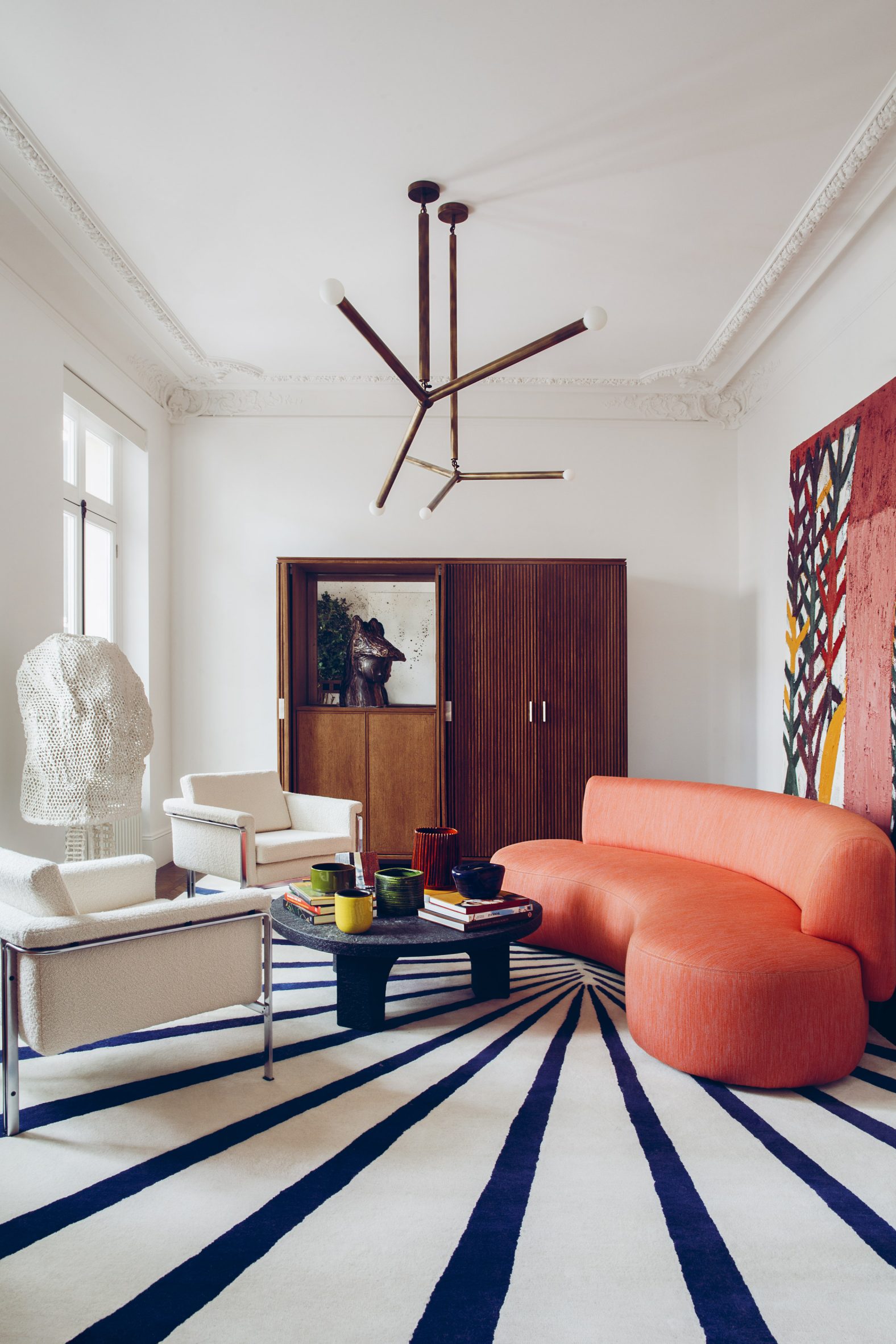 Living room with striped rug and apricot sofa