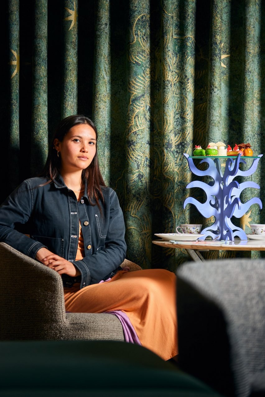 Photograph of artist, Hannah Lim with her afternoon tea stands designed for the Bvlgari collaboration.