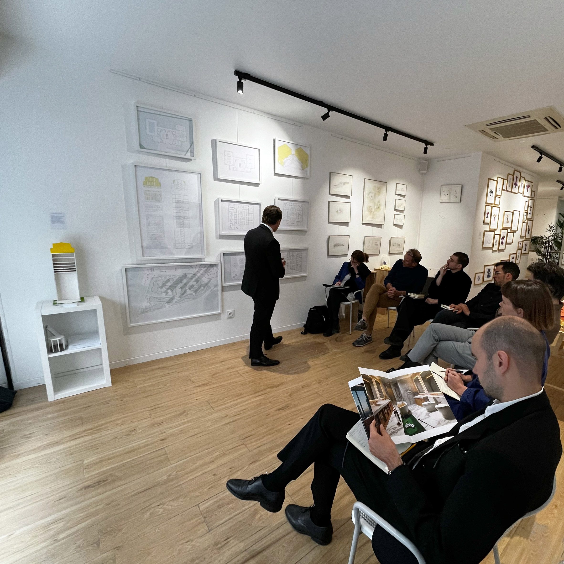 Photograph of students sitting and watching a lecturer present.