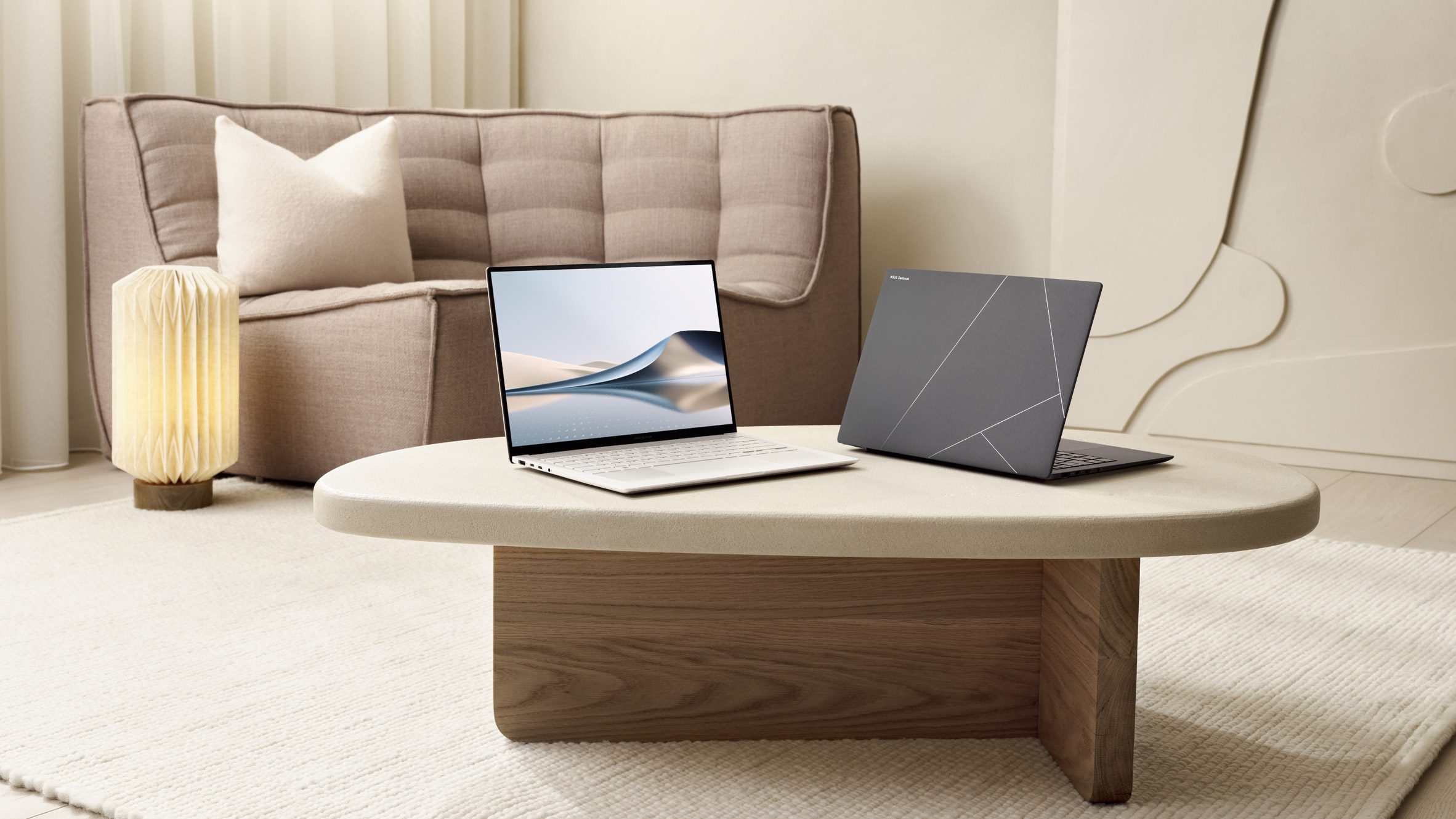 ASUS Zenbook models on a coffee table in a contemporary residential setting