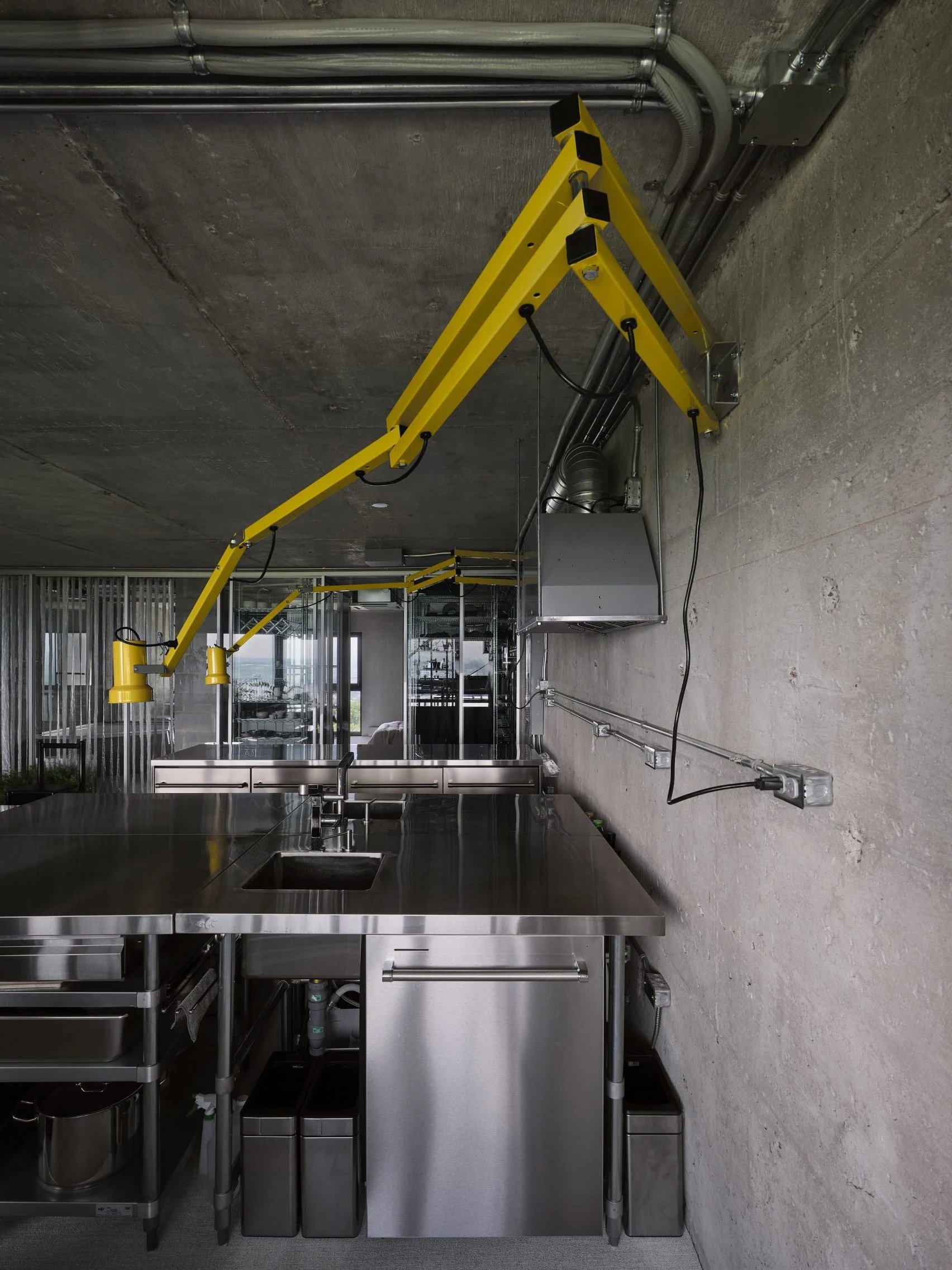 Metal kitchen counter with bright yellow lamps