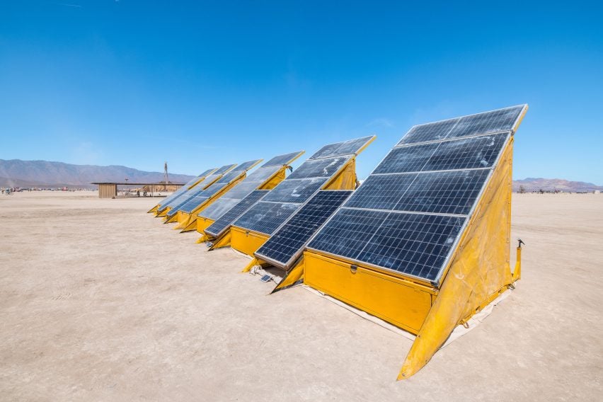 Solar panels on yellow structures in the desert