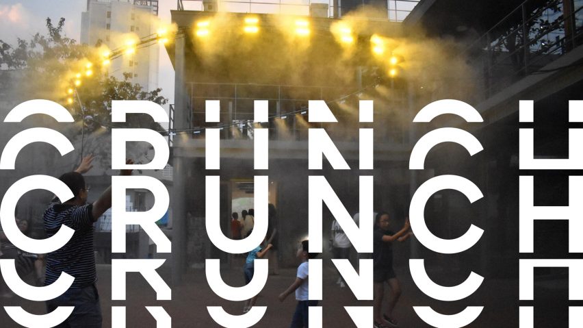 A photograph of a building masked by smoke, with yellow lights shining from it. There is distorted white text over the image that reads 'crunch'.