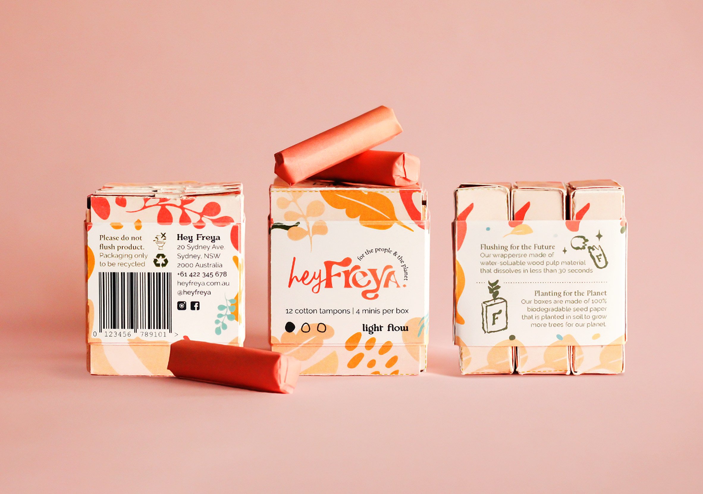 A photograph of three tampon boxes in tones of pink, orange, and red, against a pink backdrop.