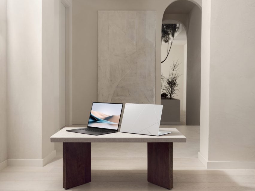 Two ASUS Zenbooks perched on a table in a contemporary interior