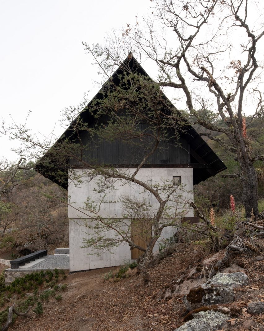 Concrete house with black gables