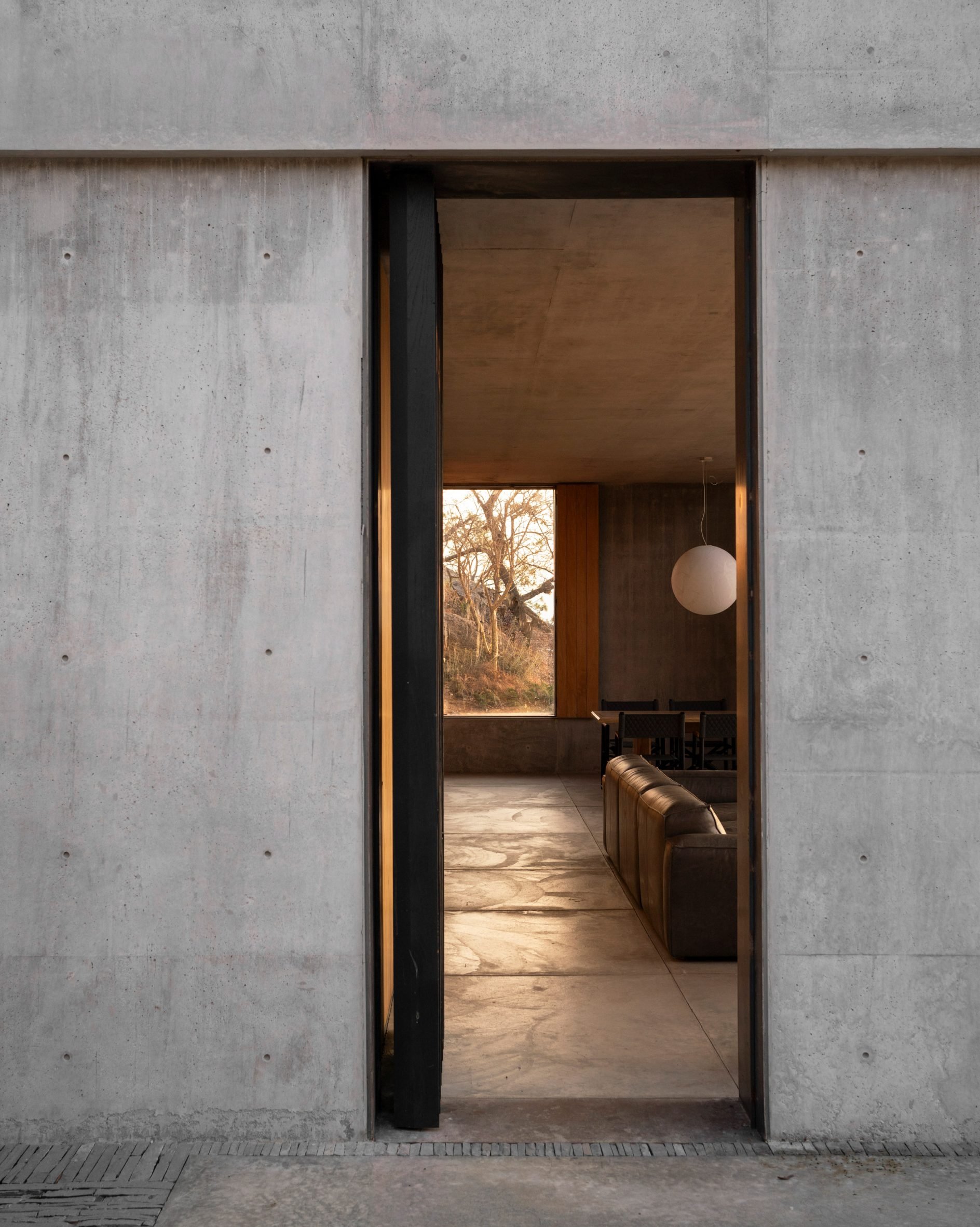 Concrete wall with doorway into living room