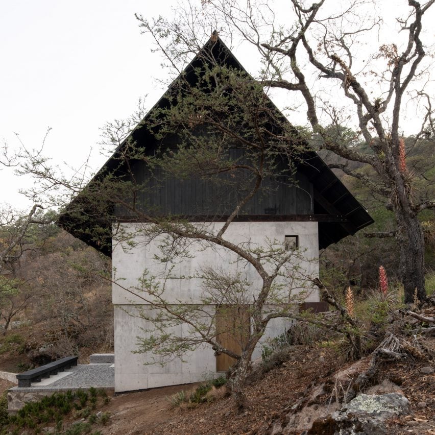 Concrete cabin with black roof