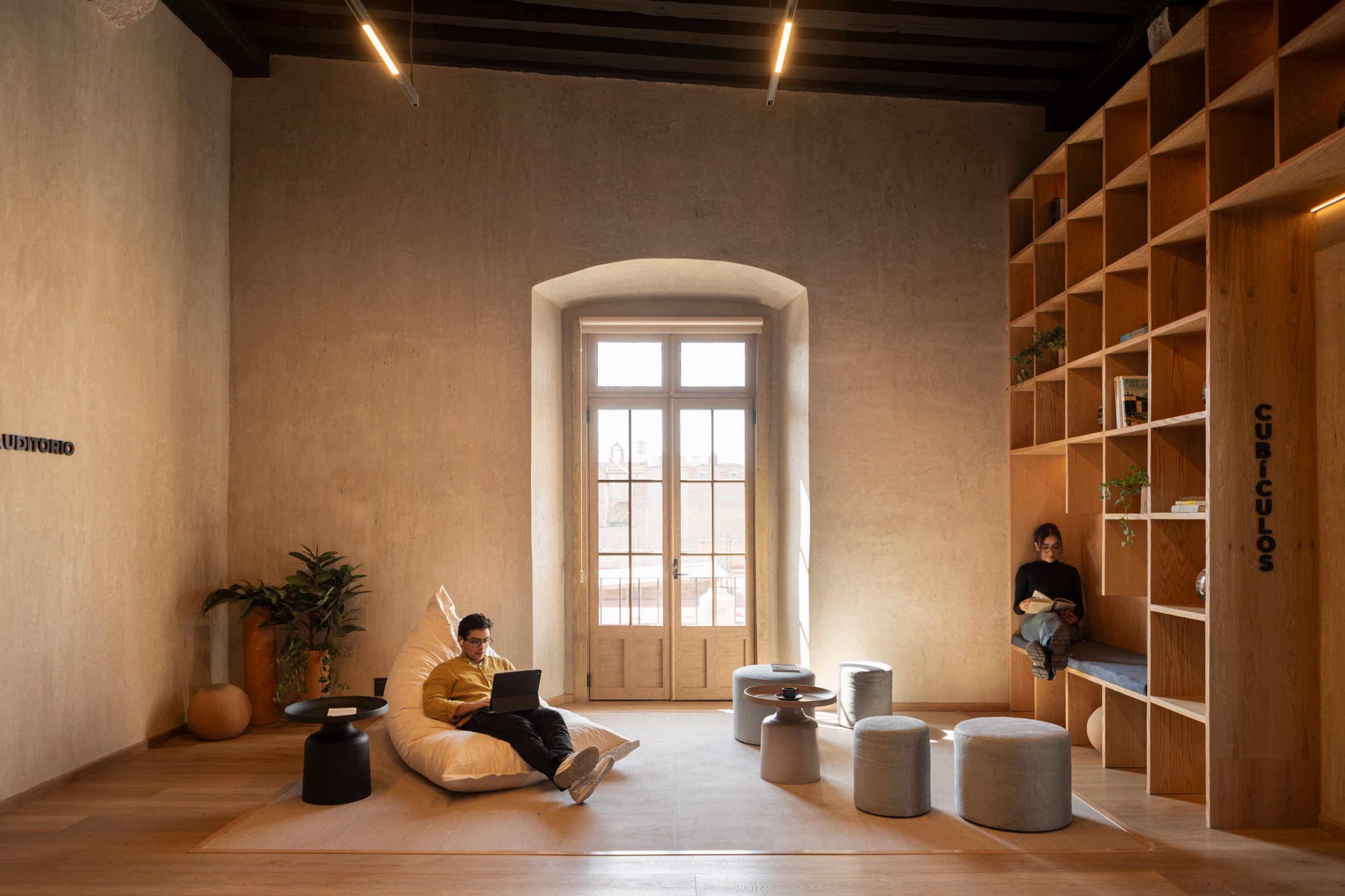 Library with a full wall of display shelving and casual furniture