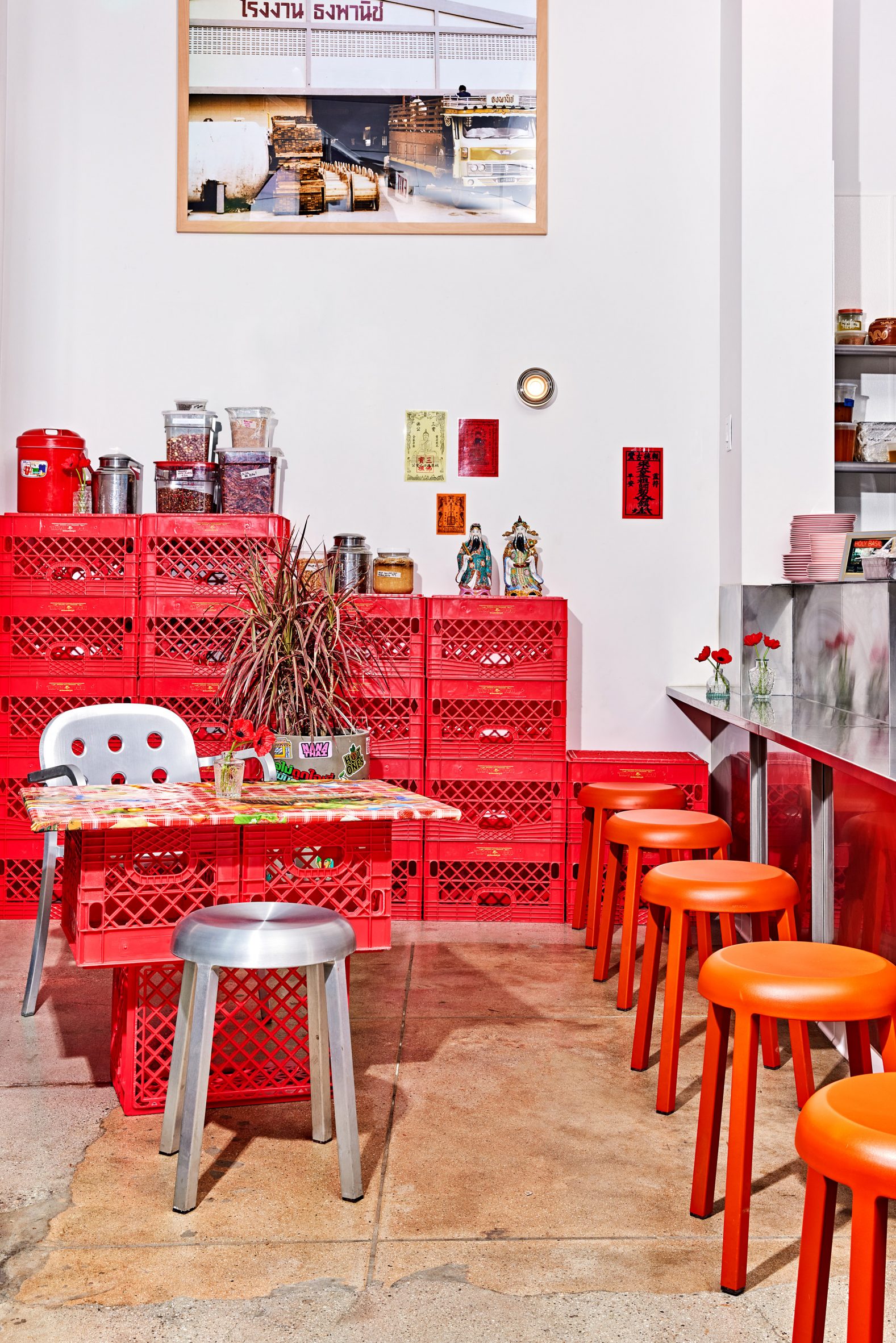 Restaurant with red boxes stacked to form shelving and tables