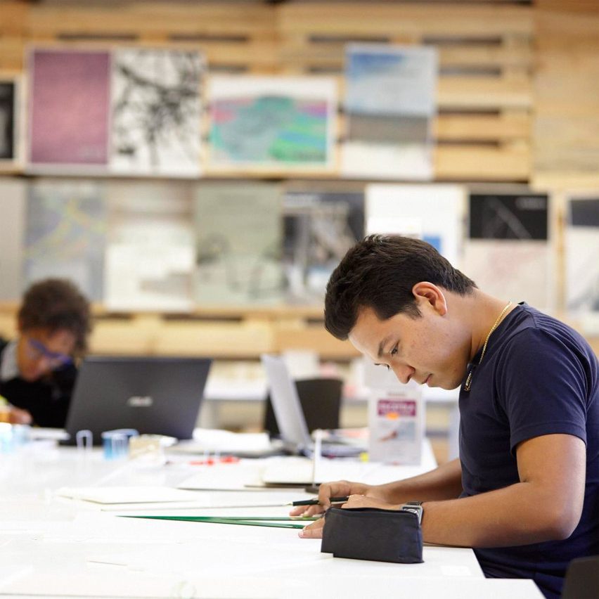 a photograph of an architecture student at a desk