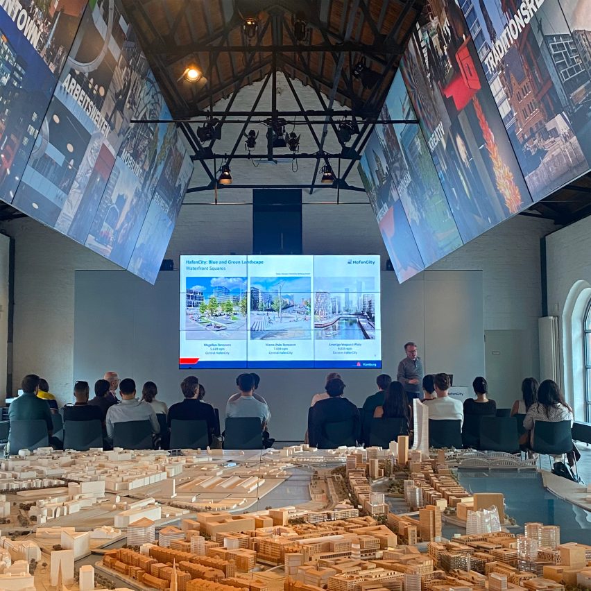 a photograph of students viewing a presentation in a hall