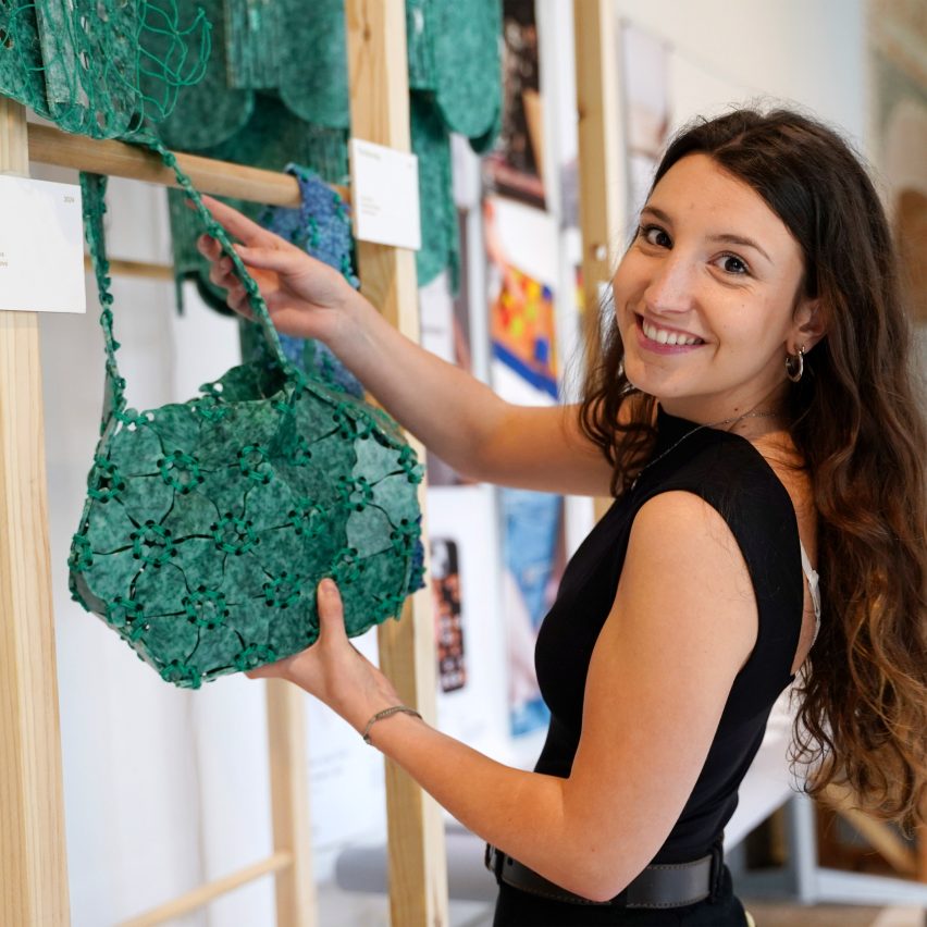 a student holding design work