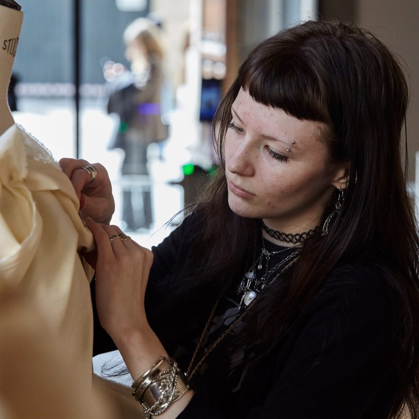 a fashion student working on a mannequin