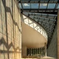 People walking under glass ceiling