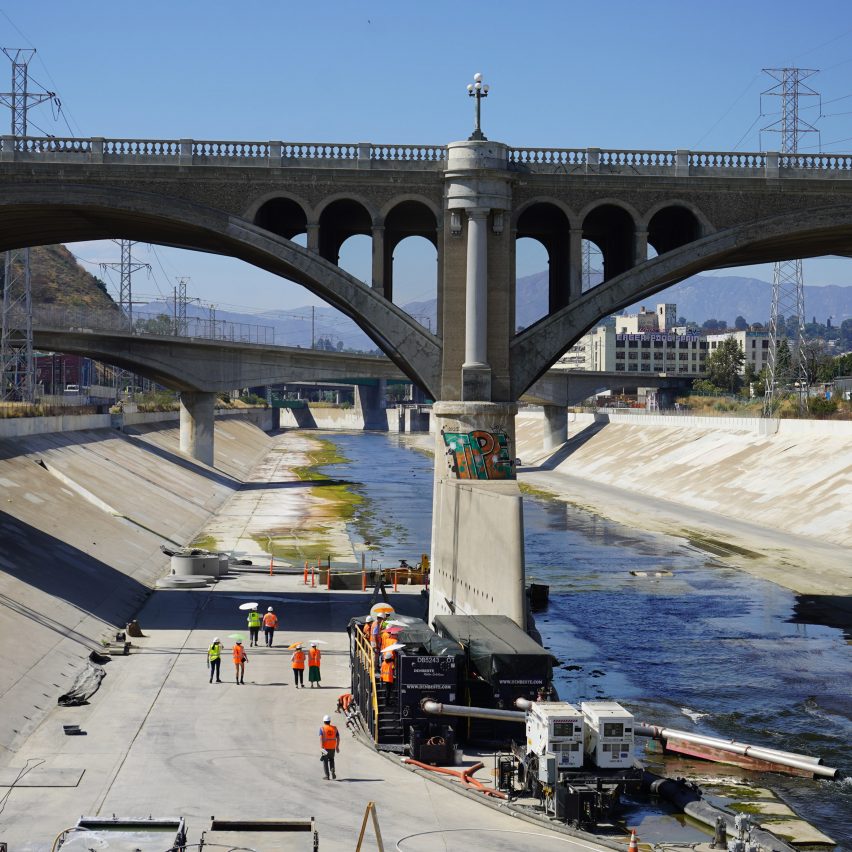 Workers digging a hole in the LA River