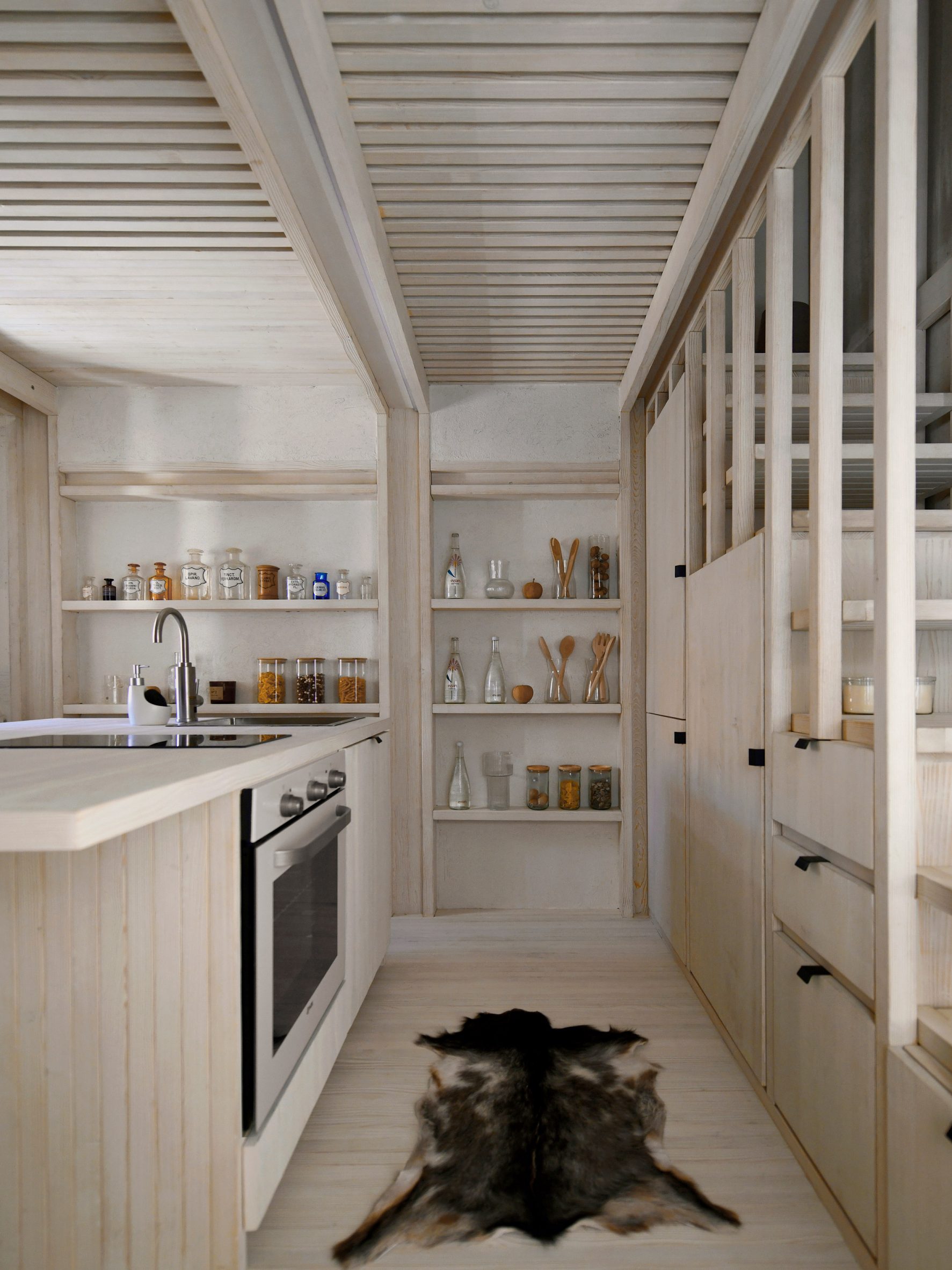 Kitchen interior within stone home by OFIS Arhitekti