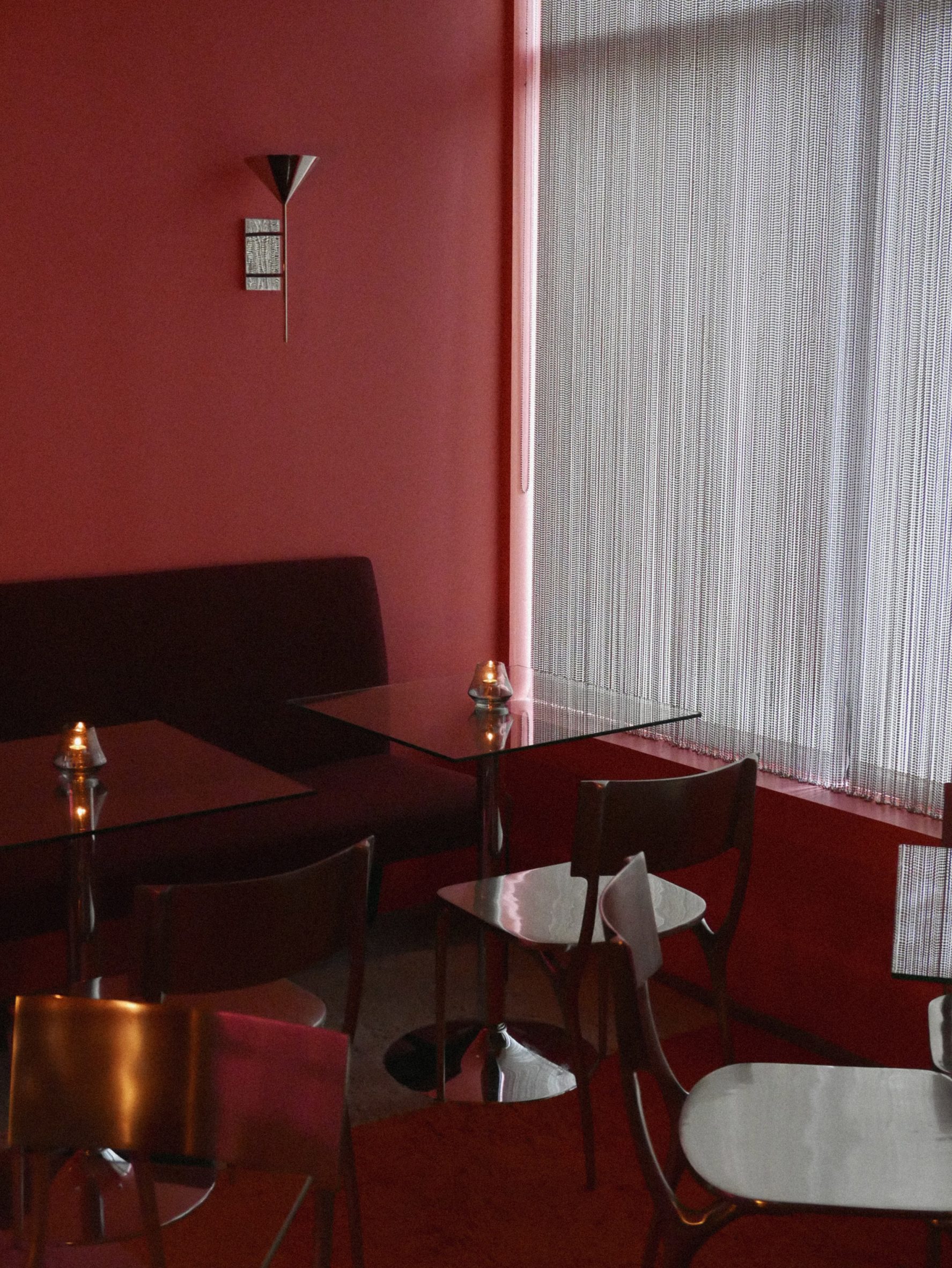 Glass and metal tables in an all-pink room