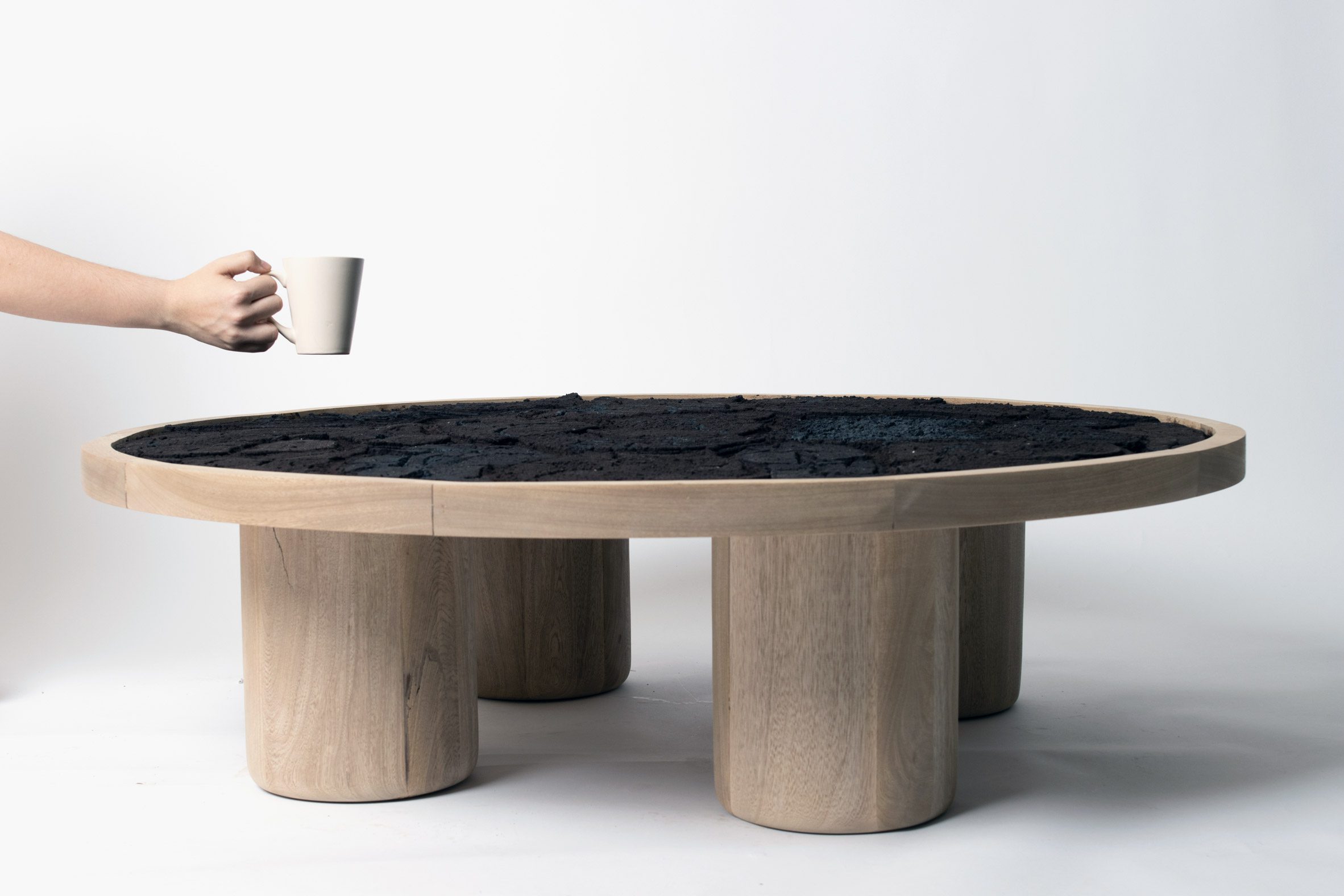 A photograph of a coffee table in tones of brown, against a white backdrop.