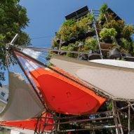 Installation with stacks of plants and tent awnings