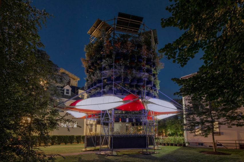 Installation with stacks of plants and tent awnings