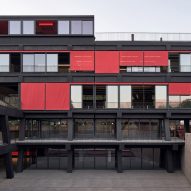 Red curtains line facade of FADEU Building at Santiago architecture school