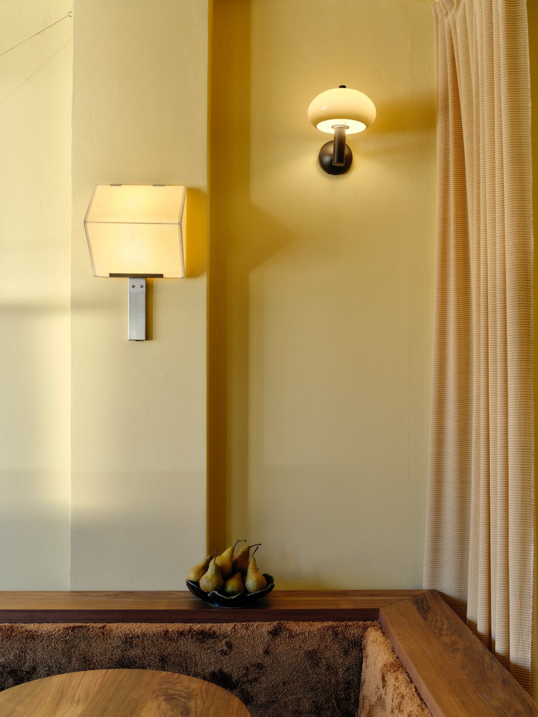 Timber joinery banquette seating and pale yellow walls