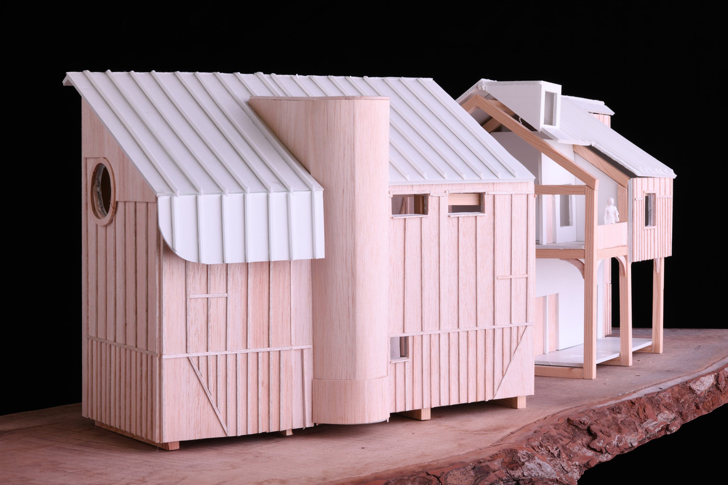 A photograph of an architectural model made solely of wood.