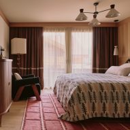 Blanket over bed, with cabinet and lamp stand