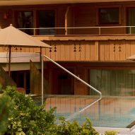 Infinity pool with balconies of chalet behind