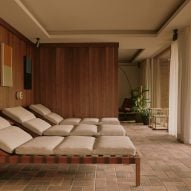 Three loungers in a wood-panelled spa