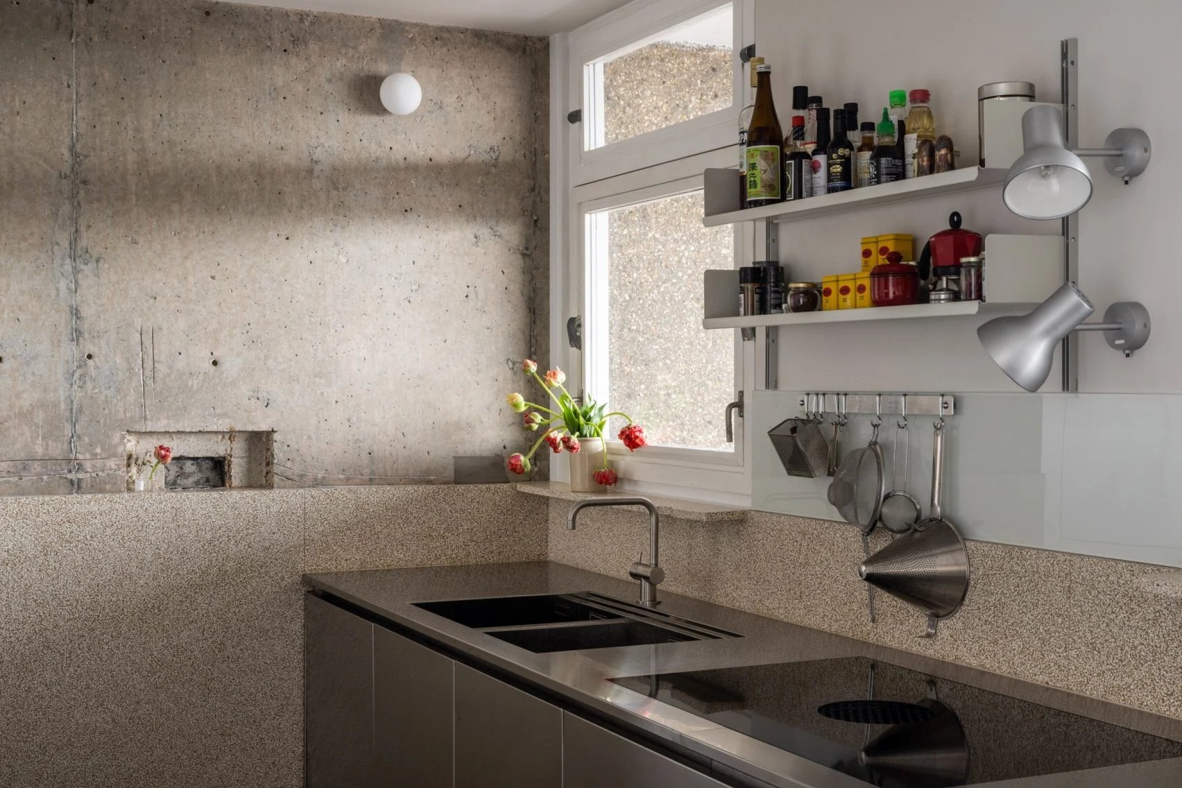 Steel kitchen counters with floating shelves above