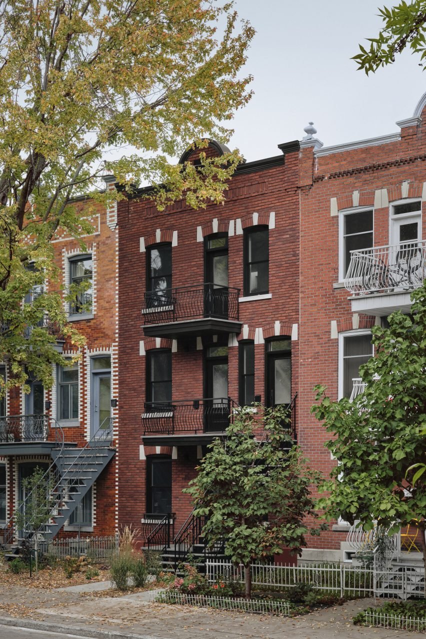 Red-brick facade of triplex building in Montreal