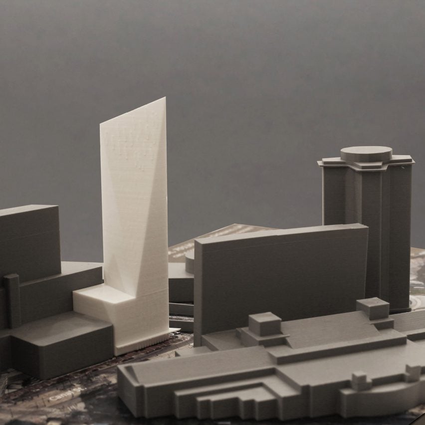 A photograph of architectural models of buildings in grey and white.