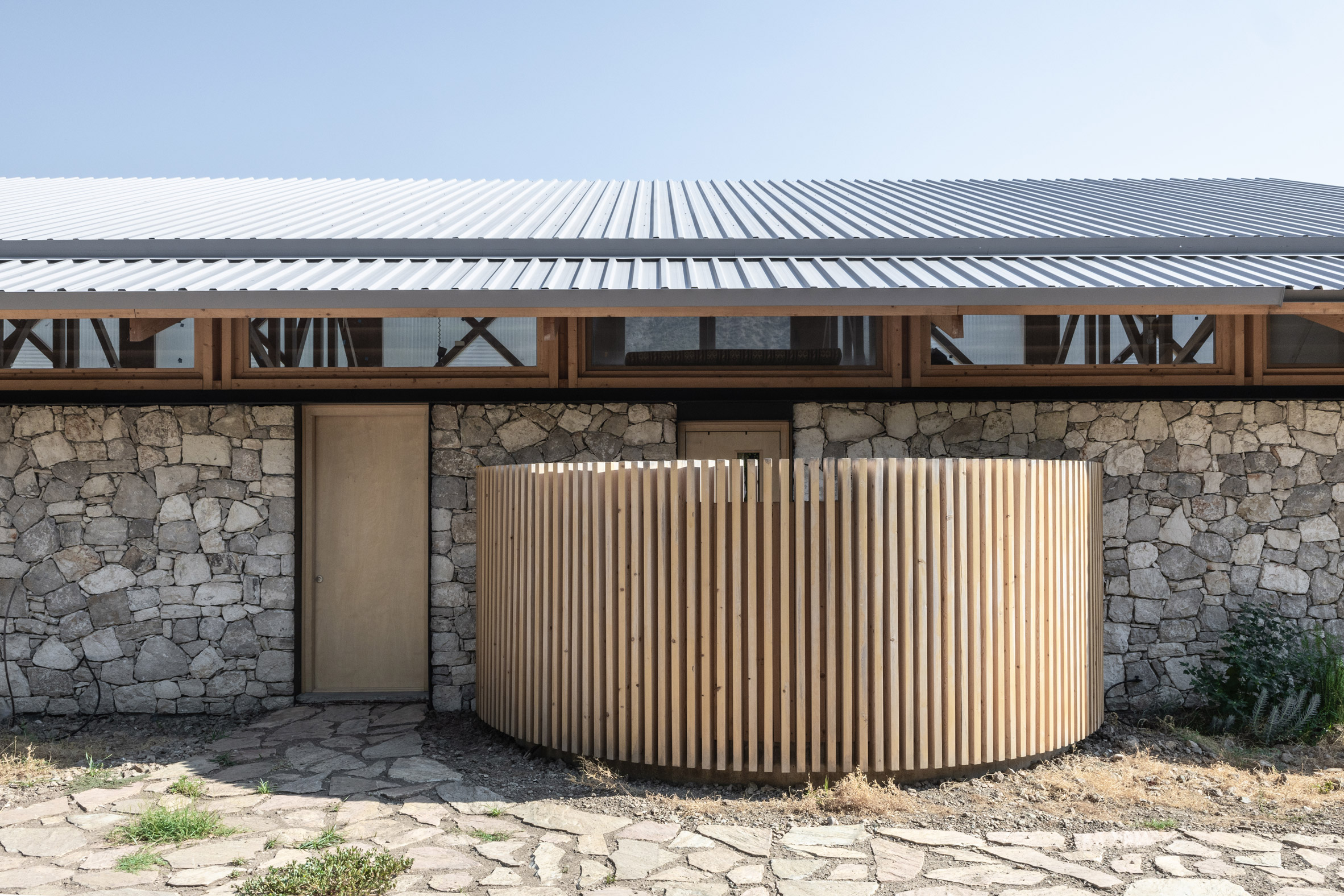 Exterior of stone house with open-air bath