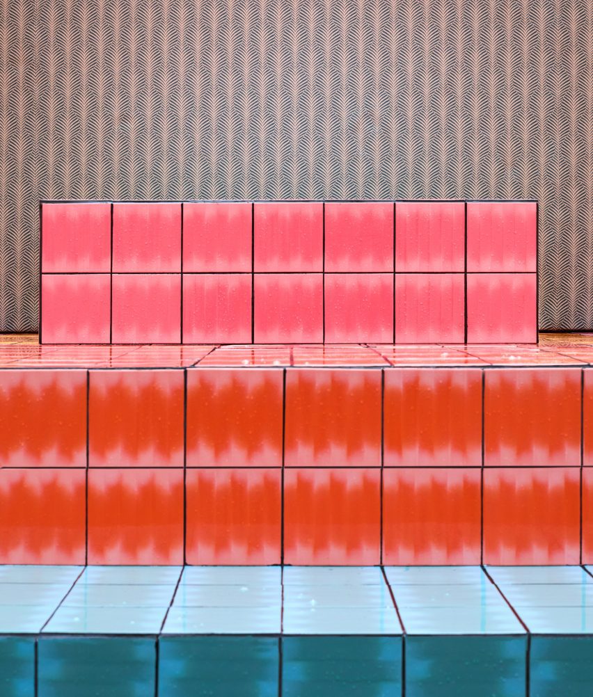 A photograph of steps in covered in blue, red and pink tiles.