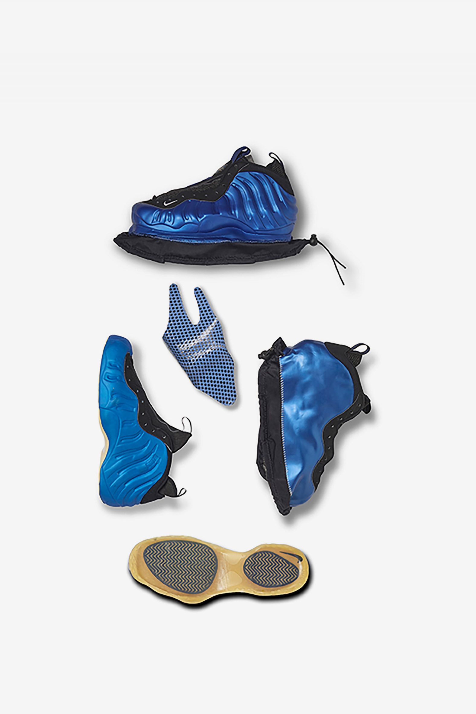 A photograph of a deconstructed blue trainer against a white backdrop.