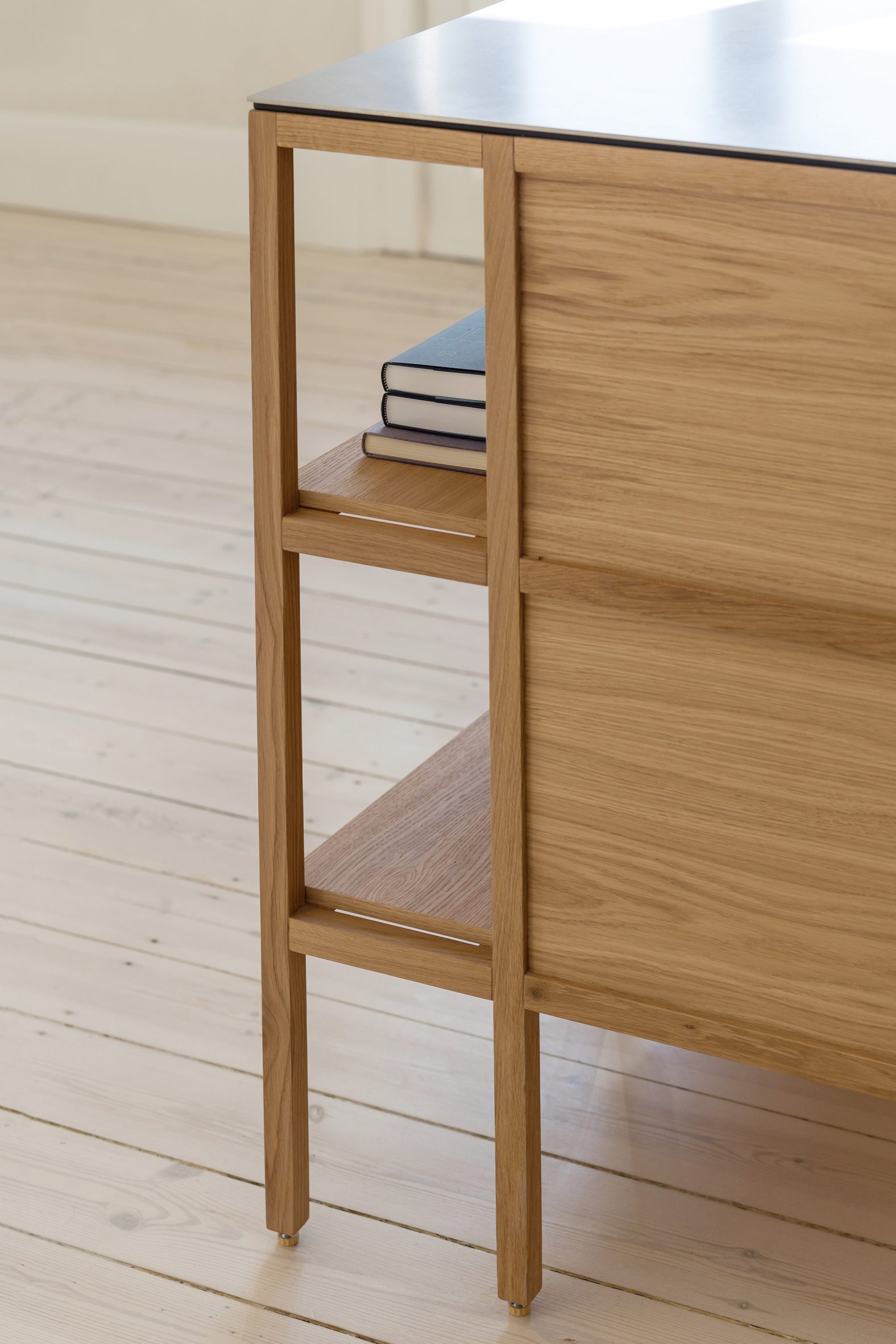 Close-up of a timber kitchen island with a metal top