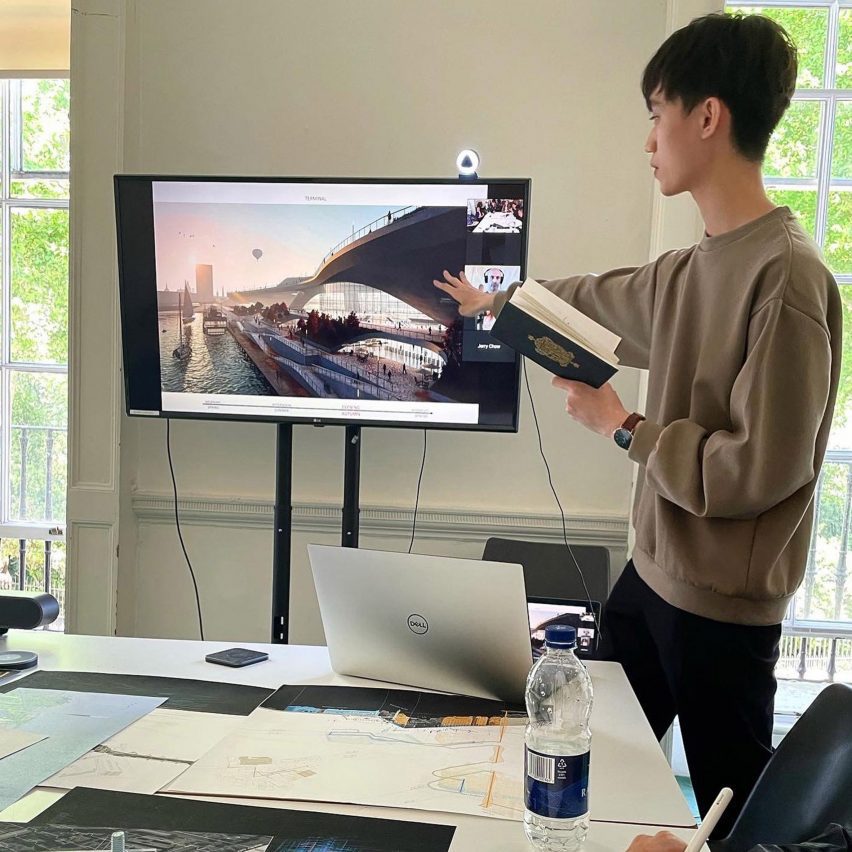 Photograph of a student presenting his work on a monitor.